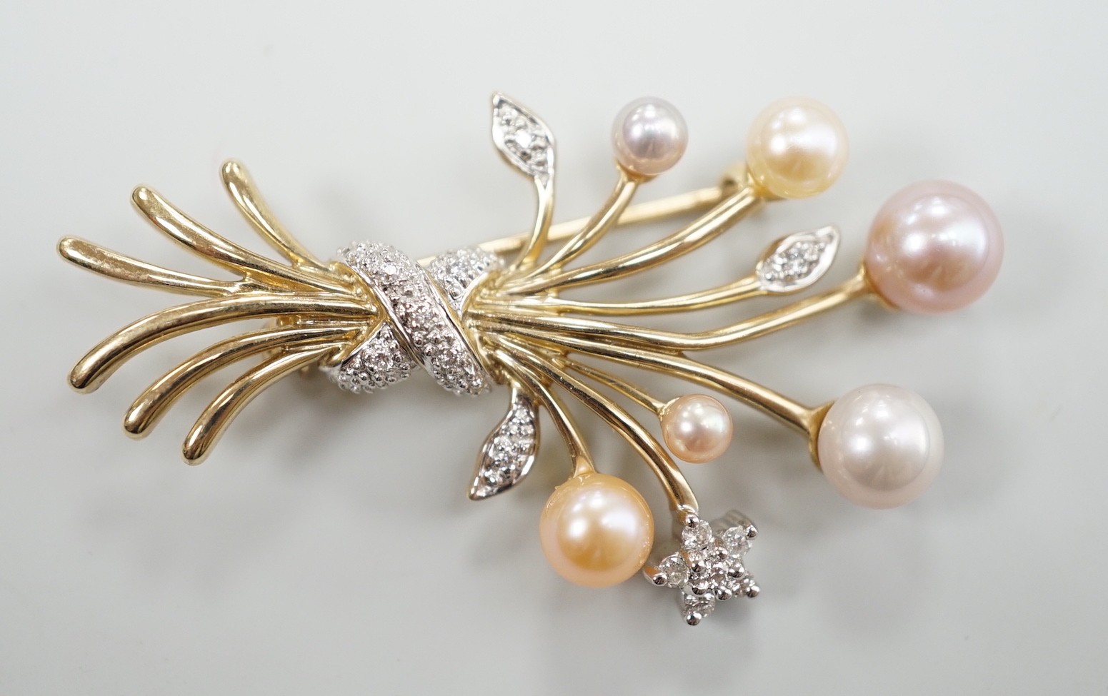 A modern 375 yellow metal, diamond chip and multi coloured graduated cultured pearl set spray brooch, 45mm
